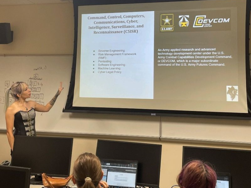 Industry guest speaking at a WiCyS outreach event